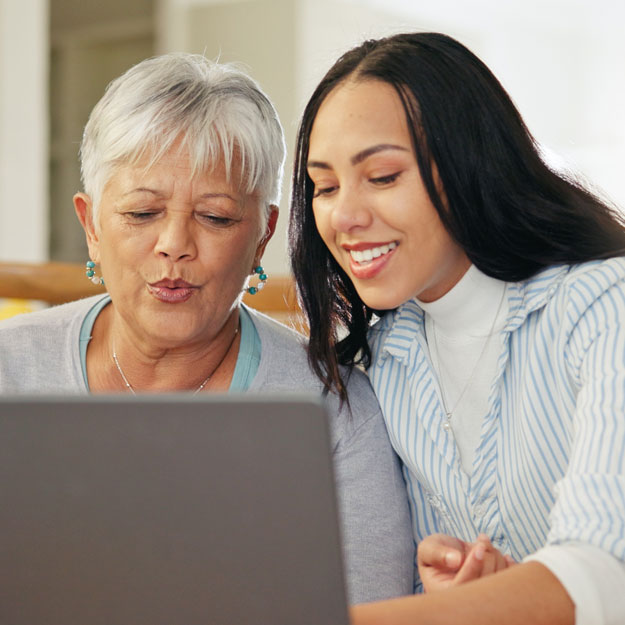 Two women looking at laptop